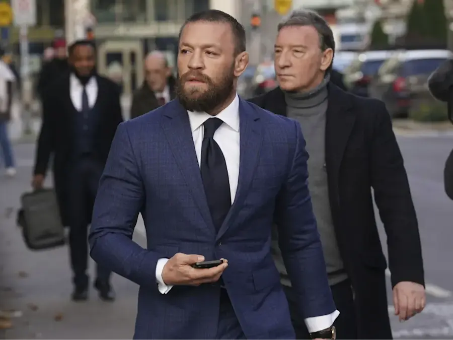 Conor McGregor walking with his phone on hand