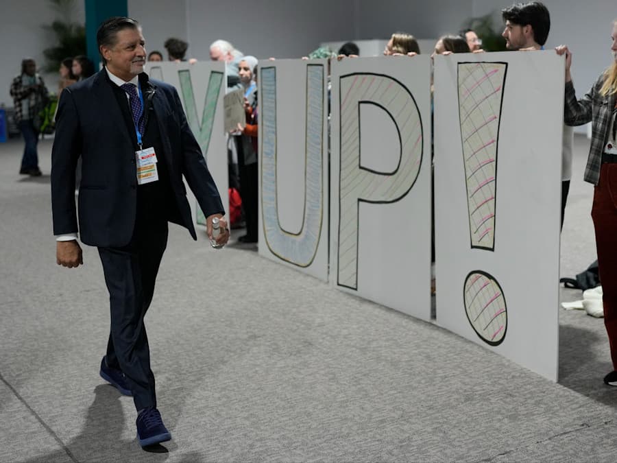 Delegate walking among protestors