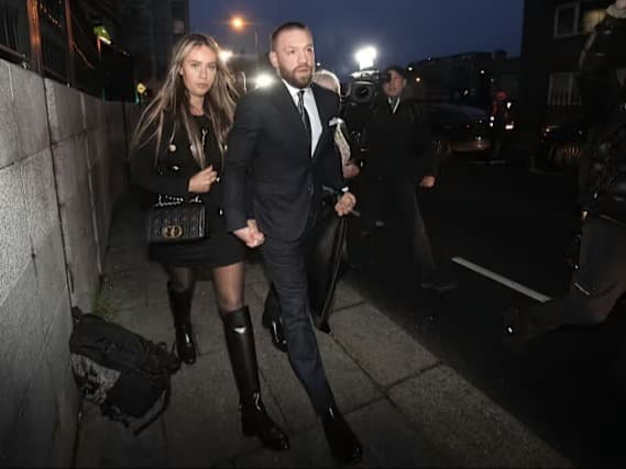 Conor McGregor waling with his partner on the street holding hands