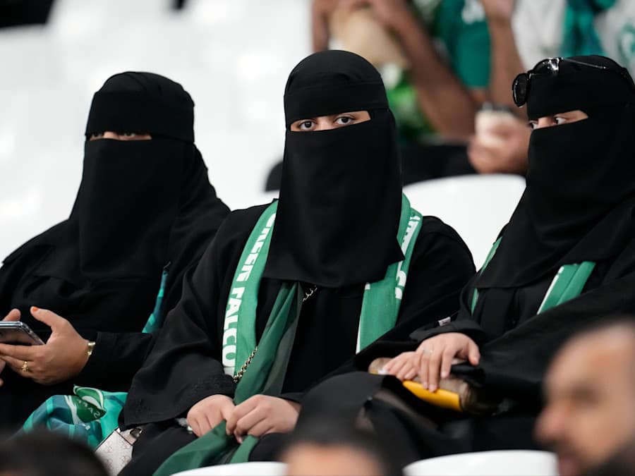 A group of women, once looking directly at the calendar.