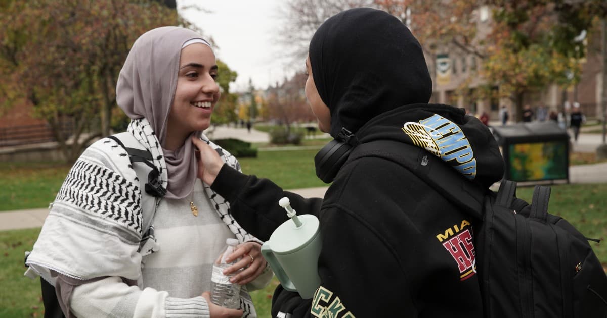 Sukkar and Mamoud chat excitedly at Wayne State University